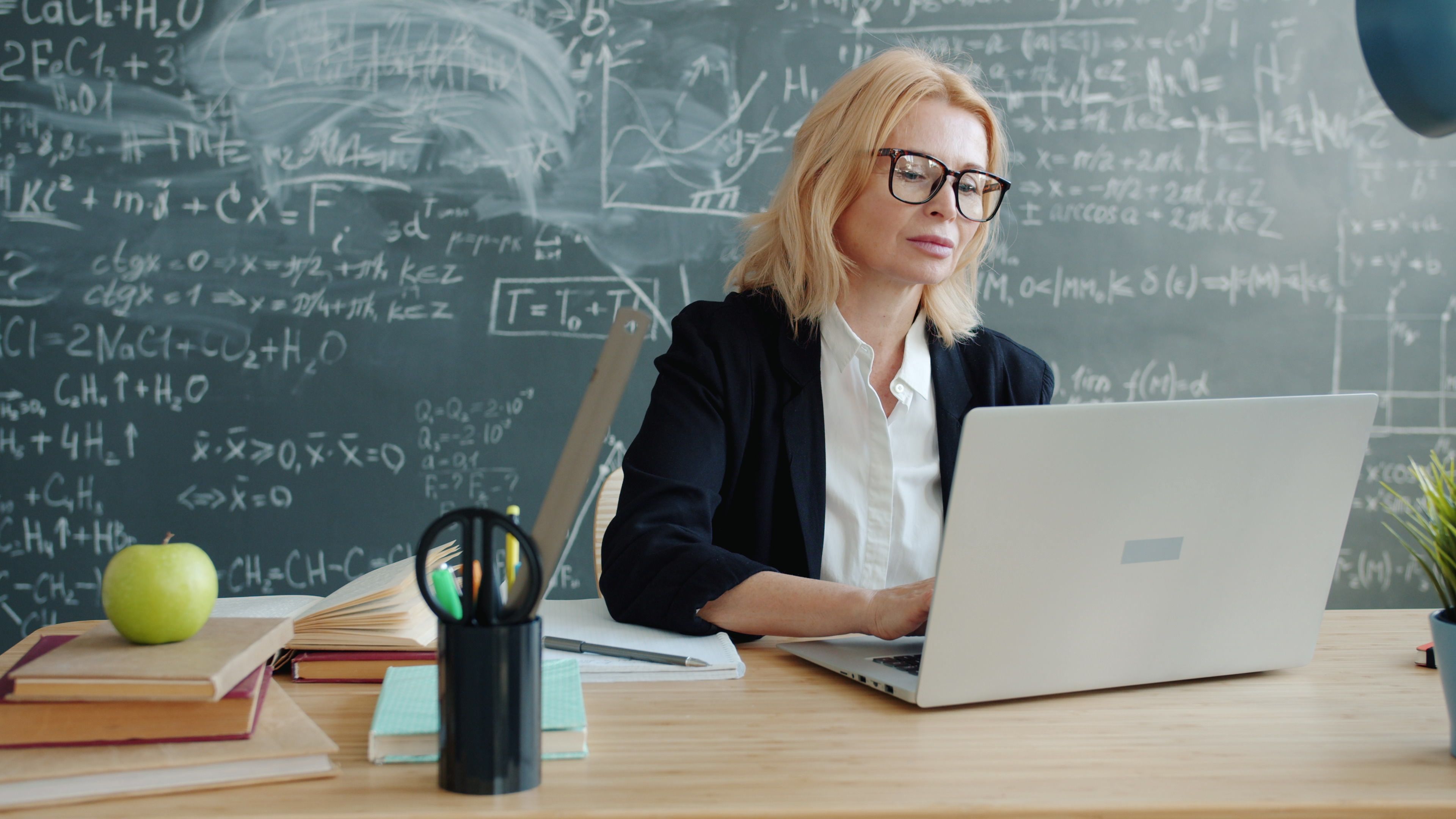 Headteacher using school MIS system in classroom